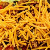 Taco Salad · Gluten free. Iceberg lettuce topped with seasoned ground beef, Cheddar cheese, tomatoes, and...