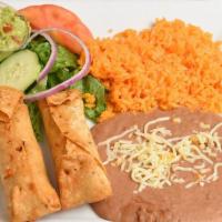 Flauta Lunch · Two golden brown flautas prepared with steak or chicken filled with melted cheese and garnis...