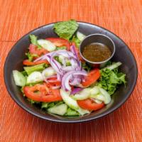 Garden Salad · Vegetarian option. Romaine lettuce, tomatoes, Persian cucumbers, and red onions served with ...