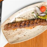 Adana · Grilled mixed lamb and beef kebab over pita bread; Served with grilled tomato and sumac onio...