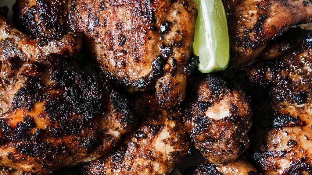Jerked Chicken (Legs & Thighs) · Charcoal grilled jerk chicken leg quarters, marinated in our jerk seasoning (cut in sections). Comes with our jerk'd kicup sauce.