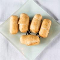 Tequenos (5 Per Serving) · Cheese sticks with Cilantro sauce