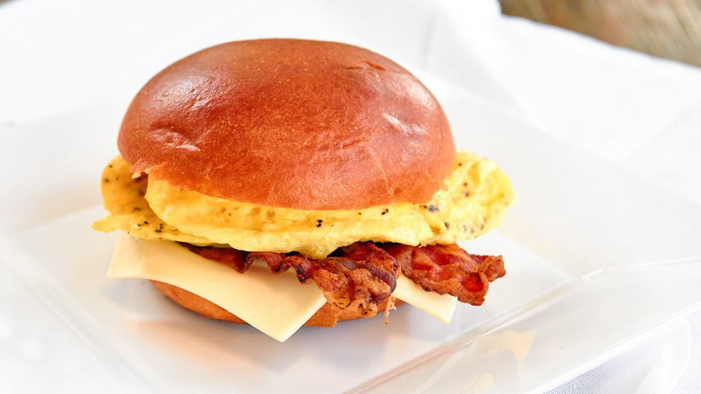Bacon, Egg And Cheese On Brioche Breakfast · Griddled bacon, farm fresh eggs and American cheese on a brioche roll. Hot.