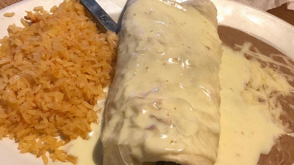 Burrito Fajita · Chicken or steak, cooked with onions, peppers and tomatoes. Smothered with cheese sauce, served rice and beans.