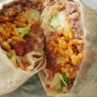 Burrito Tapatio · Chunks of steak rice and beans, sour cream, pico de gallo and guacamole. Wrapped around a la...