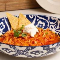 Chicken Tinga (32 Oz) · shredded chicken in a tomato-chipotle sauce with slivered onions.  Great on tacos, salads, n...