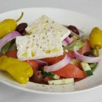 Village Salad (Horiatiki) · Gluten-free. Wedges of tomato and cucumber, tossed with red onion, bell peppers, pepperoncin...