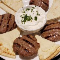 Keftethakia · Spiced beef meatball patties, flame broiled, served with tzatziki and pita.