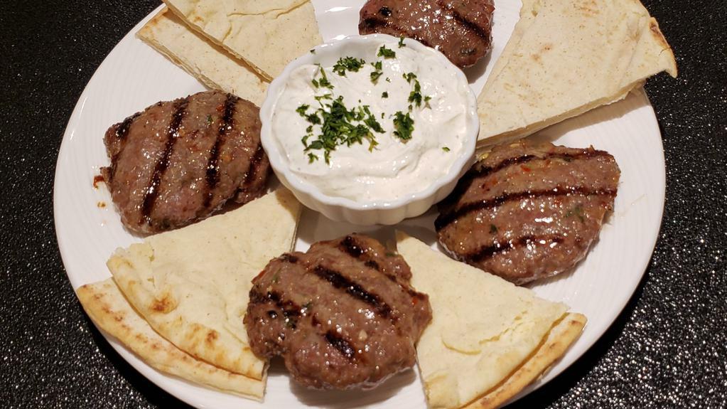 Keftethakia · Spiced beef meatball patties, flame broiled, served with tzatziki and pita.