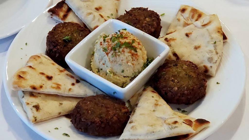 Falafel Appetizer · Vegan, gluten-free. Patties of ground chickpeas and beans, blended with herbs, spices and onion, served with hummus.