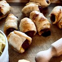 Dozen Mini Dogs · Cocktail smokies and Cheddar cheese wrapped in bagel dough.