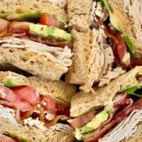 Turkey Avocado Club Sandwich · Spicy. Roasted turkey, sliced avocado, bacon, lettuce, tomato and chipotle mayo.