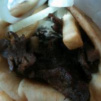 Lamb Gyro · Slow roasted rotisserie lamb. Served in pita bread with tzatziki sauce, tomato, and onions.