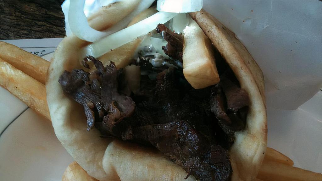 Lamb Gyro · Slow roasted rotisserie lamb. Served in pita bread with tzatziki sauce, tomato, and onions.