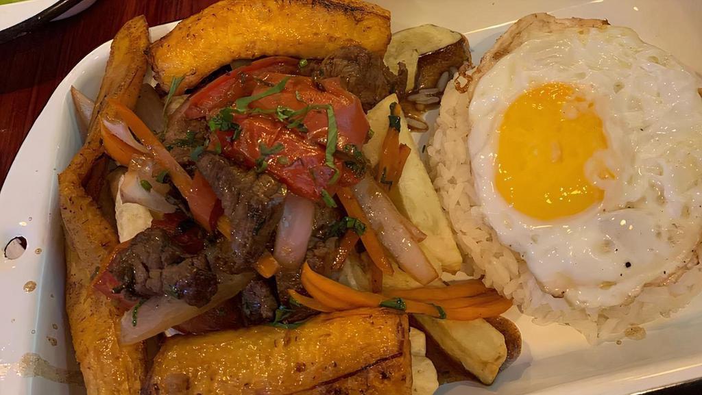 Lomo Saltado · Beef, red onions, tomato, green onion, cilantro french fries, and soy sauce mix. Served with rice.