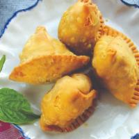 Samosa (2 Pc) (Vg) · Pastry puffs with potatoes & peas.