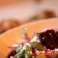 Beet Salad · Romaine lettuce, red onions, beets, red cabbage, with chef's dressing topped with feta cheese.