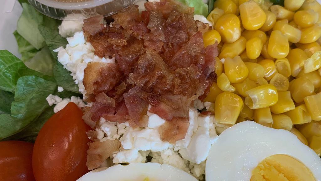 Cobb Salad Lg · A mix of freshly cut romaine lettuce,  hard boiled eggs, cucumber, goat cheese, crispy bacon and balsamic vinaigrette on the side.