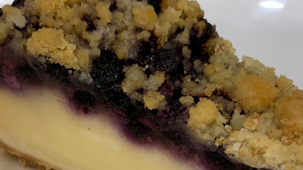 Blueberry Cheesecake · A creamy lemon cheesecake topped with blueberries and brown sugar crumbs, sits on a cookie base! Voila!!