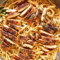Blackened Chicken Pasta · Penne pasta sautéed with cajun style alfredo sauce and toasted french bread.