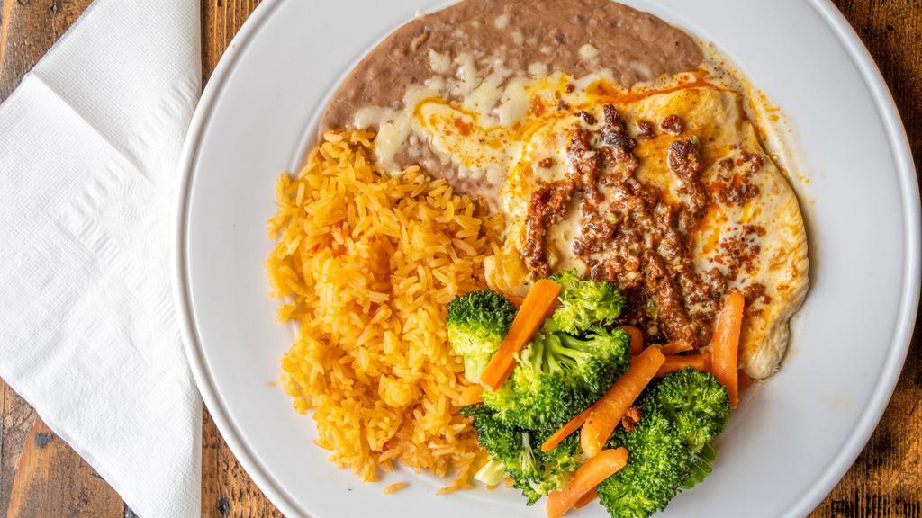 Pollo Con Chorizo · Chicken breast grilled with mexican sausage and topped with melted cheese. Served with steamed vegetables, rice, beans and tortillas.