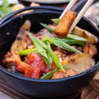 Salmon Clay Pot · Caramelized salmon, red bell pepper, yellow onions, ginger jasmine rice.