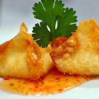 Crispy Crab Wontons · Crispy wonton wrapper stuffed with crab meat, cream cheese, ginger, green onions; served w/ ...