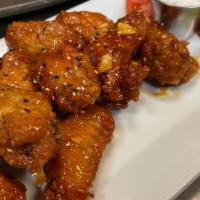 Thai Chili Wings · Crispy chicken wings tossed in spicy Thai chili sauce & lots of garlic; served with kim-chi,...