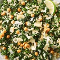 Kale Caesar Salad · Quinoa, hemp seeds, parmesan cheese, caesar, crispy chickpeas, lime wedge, kale