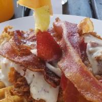The Adrian · Two waffles, fried chicken breast, topped with house made sausage gravy & four pieces of bac...