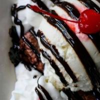Brownie · Vanilla ice cream, chocolate sauce, whipped cream, cherries.