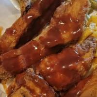 Fried Pork Ribs · Served with BBQ sauce, drizzled.