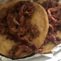 Al Pastor Taco · Roasted meat. Onions cilantro red and green salsa side of frijoles charros.