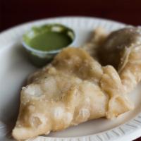 Vegetable Samosa · Seasoned potatoes, green peas and house spices wrapped in a light deep fried pastry dough.