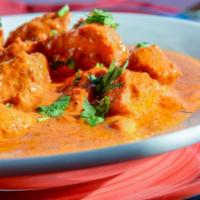 Butter Chicken · Boneless chicken cooked with creamy tomato sauce served with basmati rice.