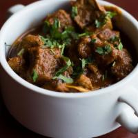 Lamb Rogangosh · Lamb cooked with fresh tomatoes, onions, ginger, garlic and house spices, served with basmat...