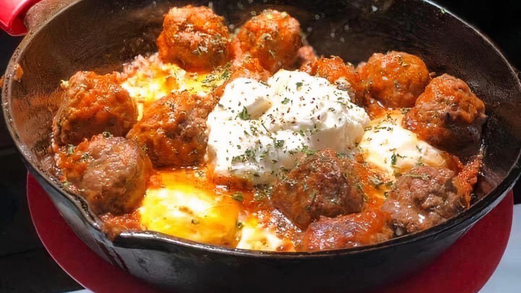 The Sunrise Tajine · Moroccan meatballs, Three sunny eggs, Vivel tomato garlic sauce, Ricotta cheese.