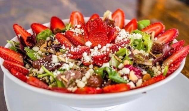Reg Vivel Salad · Organic spring mix, Organic shredded kale, Organic dates, Toasted almonds, Goat cheese, Fresh strawberries, With homemade Vivel house dressing.