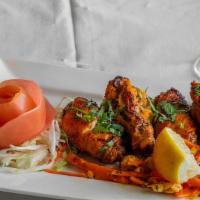 Achari Chicken Wings · Tandoori wings marinated lamb skewered and cooked in clay oven.