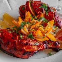 Tandoori Chicken · Chicken marinated in yogurt and freshly grounded spices and cooked in a clay oven.