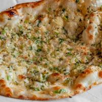 Garlic Naan · Light and fluffy white flour bread, stuffed with garlic, baked in tandoor and buttered.
