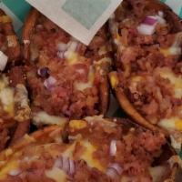 Dublin Potato Skins · Our homemade potato skins topped with crispy bacon crumbles, diced onion and creamy Cheddar ...
