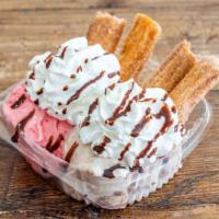 Churros With Ice Cream · Churros with two flavors of ice cream, topped with whipped cream, syrup, and topping.