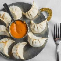 . Vegetable Momo · Steamed dumplings filled with minced cabbage, spinach, cashews, nuts, paneer, onion, cilantr...