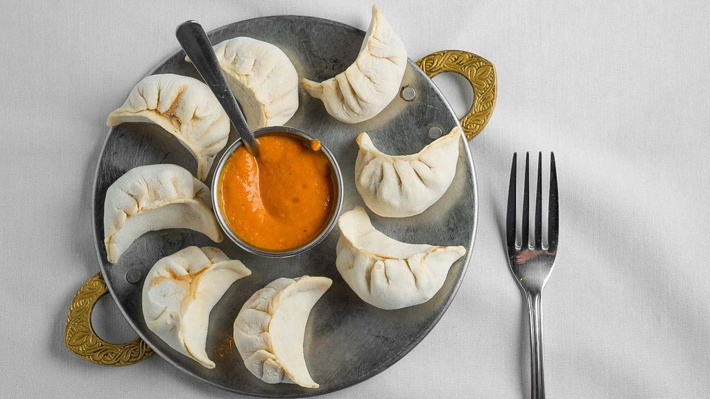 #67. Vegetable Momo (8 Pieces) · Steamed dumplings filled with minced cabbage, spinach, cheese, onion, cilantro, green onion and spices. Served with Himalayan sauce.