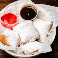 Beignets · Served warm with powdered sugar and berry or chocolate sauce (4).