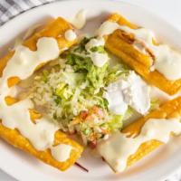 Flautas · Four com tortillas rolled with chicken, served with lettuce, pico de gallo guacamole & chees...