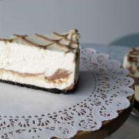 Tuxedo Cheesecake · Layers of dense chocolate and vanilla cheesecake covered in dark chocolate ganache and fresh...