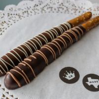 Caramel Pretzel Rod · A pretzel rod dipped in handcrafted caramel and then in chocolate, available in milk or dark.