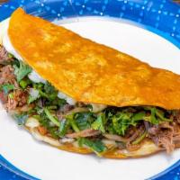 Quesataco · Big tortilla taco filled with cheese, shredded beef, cilantro and onion.